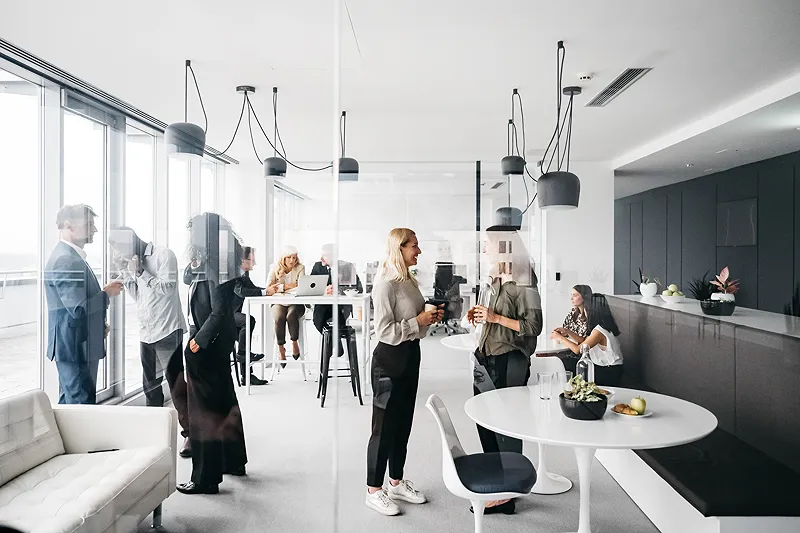 Standing people talking in office